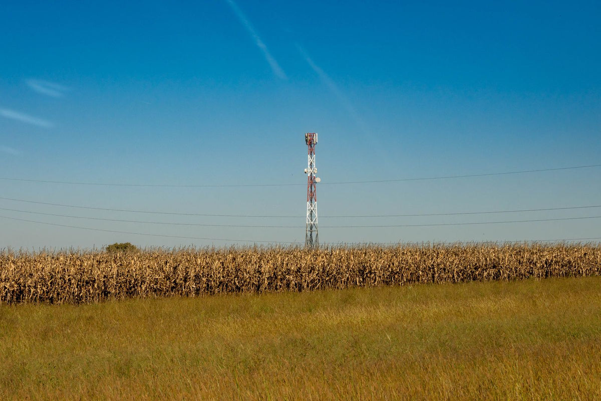 Communications tower in a rural field illustrating connectivity for remote sites
