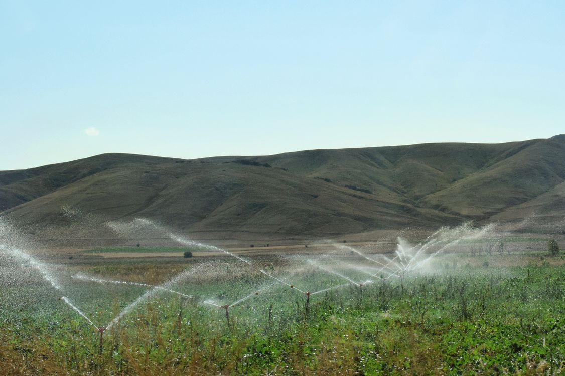 Stock photograph of sprinklers irrigating farmland